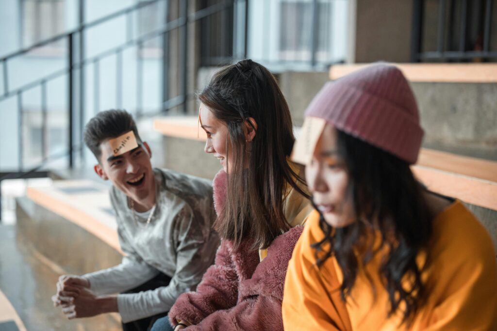A cheerful group of young friends playing a game indoors, laughing and having fun.